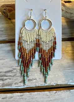 Striking hand-beaded earrings in the long fringe style.  Two pair are inspired by beautiful cities in the Southwest. Two pair are just simple fringe styles. Nickel and lead safe. Beaded Fringe Dangle Tassel Earrings For Festival, Fringe Dangle Chandelier Earrings For Festival, Bohemian Beaded Fringe Dangle Earrings, Bohemian Beaded Dangle Earrings With Fringe, Bohemian Tassel Earrings With Beaded Fringe, Bohemian Chandelier Earrings With Fringe And Round Beads, Bohemian Long Drop Fringe Earrings, Artisan Fringe Tassel Dangle Earrings, Artisan Tassel Dangle Earrings With Fringe