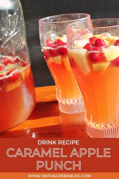 three glasses filled with drink sitting on top of a wooden table