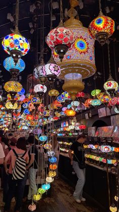 many colorful lights are hanging from the ceiling