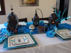 the table is set with blue and silver decorations