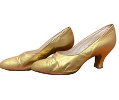 A very stylish pair of 1930's  kid leather gold shoes size UK 6.   Lovely soft leather the shoes with a high vamp which gives them a very stylish appearance.. They  are marked as a six and they seem true to size. Narrow rounded toe, and slightly splayed heel. Leather soles and tips.  Such a wonderful shoe that will complement any outfit.  Measurements These will best fit a UK 6  but to ensure that they will fit you properly, please compare the measurements below to a similar pair you already own Classic Gold Closed Toe Heels, Classic Gold Round Toe Heels, Classic Gold Heels With Round Toe, Classic Gold Heels With Leather Sole, Gold Heels With Leather Sole And Closed Toe, Gold Closed Toe Heels With Leather Sole, Vintage Gold Leather Heels, Vintage Gold Closed Toe Heels, Vintage Gold Heels For Formal Occasions