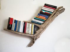 a book shelf made out of driftwood with books on it