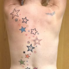 the back of a woman's body with colorful stars on her left and right side