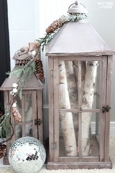 an old wooden lantern with pine cones and other decorations