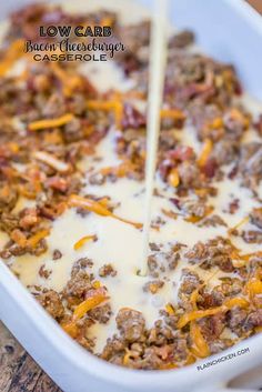 a casserole dish with meat and cheese being poured into the casserole