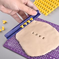 a person is making a craft with yellow letters