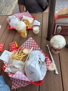 two baskets filled with food sitting on top of a wooden table