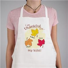 a woman wearing an apron that says i am thanksgiving