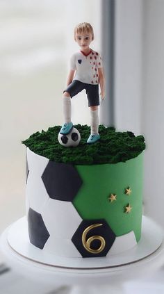 a cake with a soccer player on top