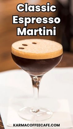 a close up of a drink in a glass on a table with the words classic espresso martini