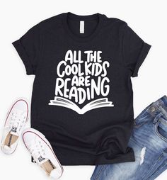 Do you want to be the coolest teacher on campus? Well, with this reading teacher shirt, you can show your dedication to teaching and reading by dressing up like the rest of the cool kids! This shirt is perfect for any teacher who wants to show off their love for books and literacy. Plus, they make a great gift for any reading teacher in your life! ~~All The Cool Kids Are Reading~~ Screen printed design on a regular unisex fit soft style tee. You may choose your shirt color from the drop down men Teacher Reading Shirts, Teacher Shirts For Men, Teacher Life Shirt, Shirts About Reading, Reading Shirts For Teachers, Reading Tshirt Ideas, Book Tshirt Design, Teacher Graphic Tees, Reading Teacher Quotes