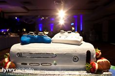 a cake made to look like a video game controller and strawberries on the table