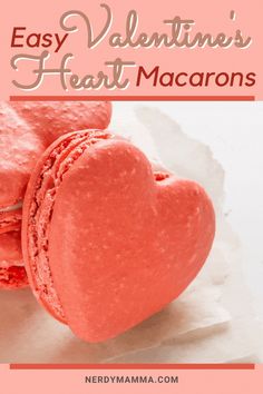 two heart shaped macarons sitting on top of each other with the words easy valentine's heart macaroons