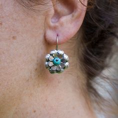 .925  Sterling Silver Flor Mazahua Flower Drop Earrings Handmade in Taxco, Mexico With a delicate flower and a central man-made stone, these earrings handcrafted in Taxco celebrate the simple elegance of nature. They resonate with the Mazahua appreciation for floral beauty, making them a meaningful gift for anyone who values artisanal craftsmanship. .925 Sterling Silver Earrings. Handmade in Taxco, Guerrero, using special chiselling and oxidizing of silver for details. Available in different col Traditional Sterling Silver Flower-shaped Earrings, Traditional Sterling Silver Flower Earrings, Traditional Sterling Silver Earrings In Flower Shape, Bohemian Silver Earrings With Flower Charm, Traditional Sterling Silver Flower Shaped Earrings, Bohemian Sterling Silver Jewelry With Flower Charm, Handmade Traditional Sterling Silver Flower Earrings, Bohemian Sterling Silver Pierced Flower Earrings, Bohemian Sterling Silver Flower Earrings For Gift