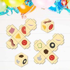 an overhead view of several boxes with different foods on them and balloons in the background