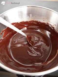 melted chocolate in a metal bowl with a spoon