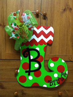 a door hanger with a green and red polka dot stocking