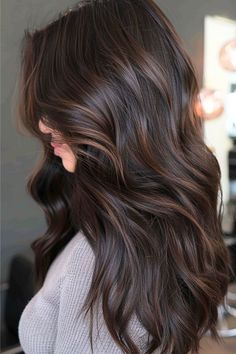 The deep, dark brown base is like the classic little dress of hair colors, but those medium brown highlights are weaving in some serious dimension. With the added bonus of additional dimension from the soft waves, this hairstyle is like a warm hug for your locks - comforting, effortless, and oh-so-chic! Click here to see more stunning dark brown hair color ideas. Long Haircuts For Brunettes, Brunet Hair With Low Lights, Dark Hair Makeover, Black Hair With Chocolate Brown Balayage, Chocolate Espresso Hair Color, Toning Hair Darker, Long Dark Brown Hair With Lowlights, Latte Highlights On Dark Hair, Dynamic Brunette Hair Color