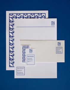 three envelopes with blue and white designs on them