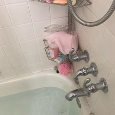 a bathtub filled with lots of soap and toothbrushes