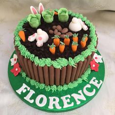 there is a cake that has carrots and grass in the shape of a garden