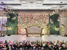 a stage decorated with flowers and greenery