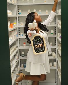 a woman holding a sign in a pharmacy aisle