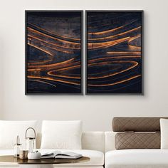 two paintings on the wall in a living room with white couches and coffee table