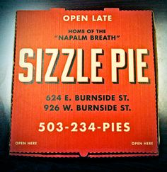 an orange sign that says sizzle pie on it