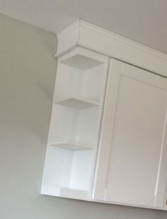 a kitchen with white cabinets and cupboards in it