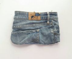 an old pair of jeans with a hole in the back pocket that has been stitched together