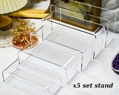 three clear acrylic trays sitting next to each other on a white table