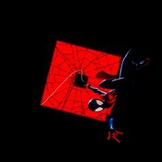 a spider - man hanging upside down in the dark