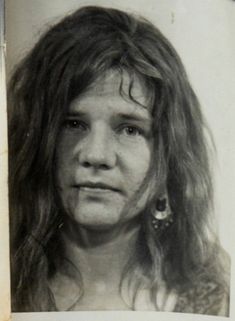 an old black and white photo of a woman with long hair