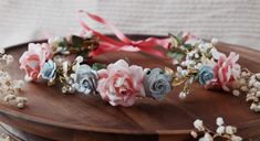 Embrace the enchanting allure of a seaside celebration with our Coastal Romance Flower Crown. This exquisite accessory combines the delicate hues of pink coral and light blue, perfect for a beach wedding or any ocean-inspired event. Handcrafted with meticulous care, this flower crown will add a touch of coastal charm and elegance to your special day. Features mulberry roses of coral pink and dusty light blue. Adorned with pearl branches, sparkles, and hints of gold leaves. Design is adjustable and fits 1 year to adult. Simply tie the set of 17 inch ribbons in the back for an easy to wear style! Flower Crown Pink, Blue And Blush Wedding, Crown Pink, Mermaid Fairy, Wedding Wreath, Wedding Wreaths, Floral Headband, Leaves Design, Flower Hair Comb