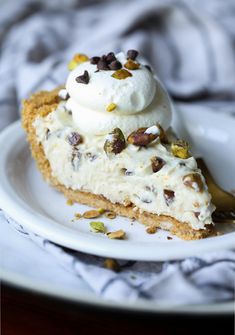 a piece of pie with whipped cream and nuts on top