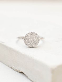 "Our disc ring is simple and elegant. It is made with fine and tiny CZ's to get the ultimate shine and sparkle. This ring looks great on it's own or stacked with our other rings! Ring is Small and Dainty! Material: Brass Color: Silver - Rhodium Plate Setting: Micropave Height: approximately 1/2\" Listing is for one Silver colored ring. Images are meant to show you how the ring fits/looks on the hand. All other jewelry in images are available in my shop or my website. Feel free to contact me if y Stackable Halo Cubic Zirconia Rings, Cubic Zirconia Stackable Rings With Halo, Dainty Cluster Ring With Halo Setting, Minimalist Single Cut Diamond Rings, Everyday White Gold Diamond Ring, Silver Diamond Ring With Round Cut, Everyday Silver Diamond Ring With Round Cut, Dainty Diamond Ring With Single Cut Diamonds, Minimalist Diamond Ring With Pave Setting For Gift