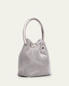 Jimmy Choo top handle bag in crystal mesh.    Metal brass bracelet top handle.    Leather shoulder strap, 21.6" drop.    Drawstring chain closure.    5.9"H x 5.5"W x 3.7"D.    "Bon Bon" is made in Italy. Evening Bucket Bag With Rhinestones, Evening Bucket Bags With Rhinestones, Elegant Bucket Bag With Rhinestones, Luxury Evening Bag With Handle Drop For Events, Elegant Rhinestone Bucket Bag, Silver Shoulder Bag With Round Handle For Evening, Luxury Bucket-shaped Evening Bag For Formal Occasions, Luxury Bucket Evening Bag For Formal Occasions, Luxury Bucket Style Evening Bag For Formal Occasions