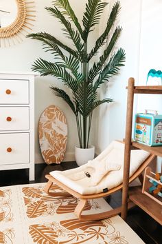 a living room with a chair, potted plant and dresser