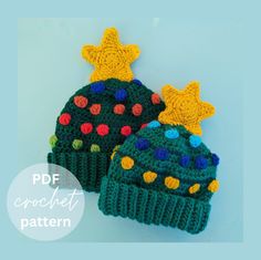 two crocheted hats with stars on the top and one has a green hat with multi - colored pom poms