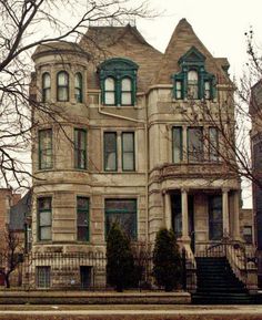 an old victorian style house with many windows