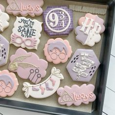 decorated cookies are displayed in a box on the table for someone's 90th birthday