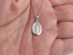 "A Fabulous 14k White Gold Virgin Mary Necklace!! * Material: 14k solid gold, Not plated or filled * Length: 5/8\" or 17 mm long not including the bail * Width: 3/8\" or 10 mm wide * Cable Chain: 16\", 18\", 20\" long by 0.8 mm thick with lobster clasp. * Length And avg weight: 16\" = 2.10 g , 18\"= 2.20 g , 20\"= 2.40 g * Complementary Gift Box included There is a prayer around Mary which says: O Mary conceived without sin pray for us who have recourse to thee. The Mary Pendant is about the sam Anniversary Pendant Necklace With Miraculous Medal, Oval Sterling Silver Necklace With Lobster Clasp, White Gold Miraculous Medal Round Pendant, Oval White Gold Necklace With Lobster Clasp, Miraculous Medal Pendant Necklace For Anniversary, White Gold Necklace With Miraculous Medal For Gift, Sterling Silver Necklace With Miraculous Medal, White Gold Necklace With Miraculous Medal As Gift, Oval Miraculous Medal Necklace For Anniversary