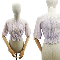 "🌟 \"Elegant Antique French Edwardian Era Blouse - A Piece of Fashion History\" 🌷 This magnificent antique French blouse, dating back to the Edwardian era, is a true gem for vintage fashion enthusiasts. Crafted from delicate batiste cotton, it features a pale lavender hue that exudes class and sophistication. ✨ Key Features: Size: Waist 66 cm, Chest from armpit to armpit 49 cm, Length 47 cm. Short sleeves and delicate mechanical lace inserts. The bodice is adorned with a faux tie, edged with s Fitted Lavender Tops For Daywear, Lavender Fitted Tops For Daywear, Victorian Style Tops For Summer Daywear, Victorian Tops For Summer Daywear, Fitted Lavender Short Sleeve Blouse, French Blouse, Edwardian Blouse, 1920 Fashion, Lavender Blouse