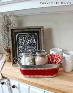 the kitchen counter is organized with jars and spices on it, along with a chalkboard sign