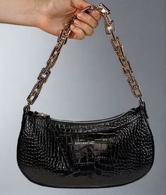 Editor's Notes: This is the must have accessory of the season for those memorable dinner and dancing evenings out on the town. It holds just the right amount of personal items without taking up much space. This handbag is made of croc printed leather with zip top opening and fashionable gold chain handle. Includes a leather strap too. Printed Italian locally sourced leather and hardware Zip top closure One zip interior pocket Two sewn in interior slip pockets Adjustable leather strap Length 11.5 Luxury Crocodile Pattern Party Shoulder Bag, Elegant Baguette Bag With Zipper For Party, Elegant Party Baguette Bag With Zipper Closure, Chic Evening Shoulder Bag With Crocodile Pattern, Top Handbags, Croc Print, Printed Leather, Black Handbags, Zip Top