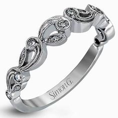 a white gold wedding ring with an intricate design