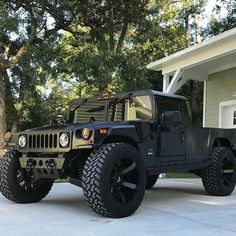 a black jeep parked in front of a house