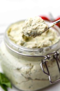 a spoon full of dip in a jar