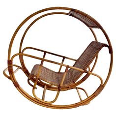 a wicker rocking chair in the shape of a circle with an armrest and foot rest